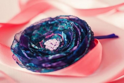 Fabric flower made of layers of blue and purple fabric