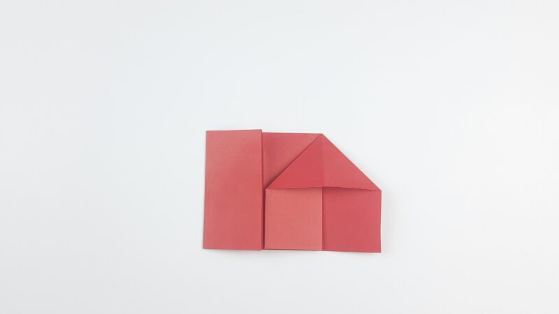 Step 8: Unfold the previous step and flatten the right section, using the diagonal crease to create a house shape