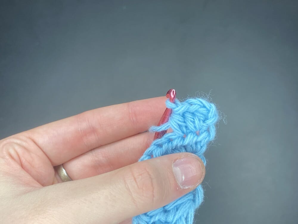 Half double crochet increase into the first stitch of the row, followed by 1 half double crochet (HDC INC, HDC)