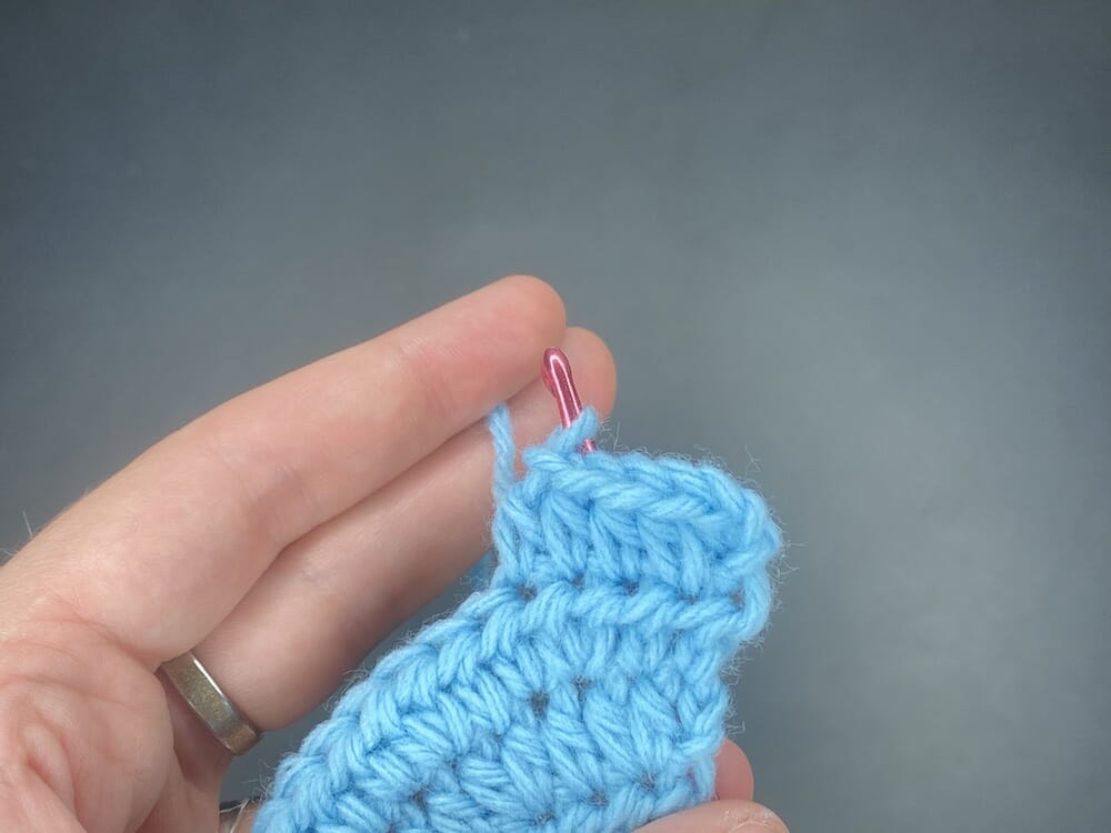 Half double crochet increase into the first stitch of the row, followed by 3 half double crochets (HDC INC, 3 HDC)