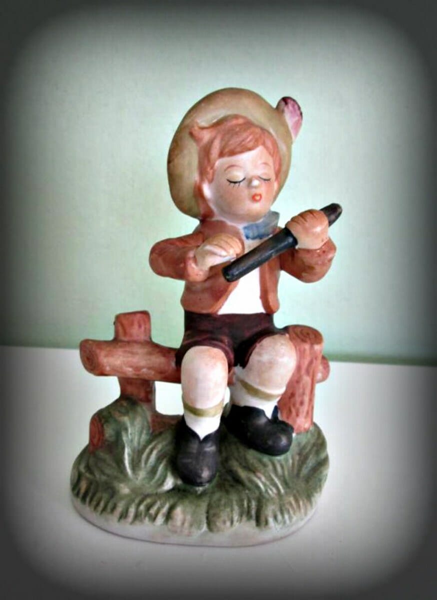 Vintage Boy Figurine Fence Sitting Flute Playing